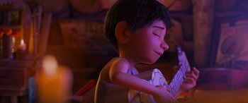 Movie still from “Coco” (2017), directed by Adrian Molina – A young boy is holding a guitar in his hands; Close Up shot, Over the shoulder angle