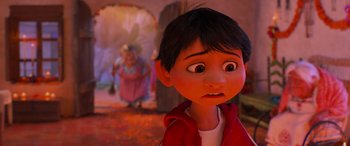Movie still from “Coco” (2017), directed by Adrian Molina – A young boy with a surprised look on his face in front of an older woman; Close Up shot, Over the shoulder angle