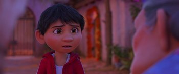 Movie still from “Coco” (2017), directed by Adrian Molina – A young boy with a surprised look on his face; Close Up shot, Over the shoulder angle