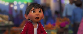 Movie still from “Coco” (2017), directed by Adrian Molina – A young boy with a surprised look on his face; Close Up shot, Over the shoulder angle