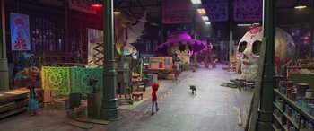 Movie still from “Coco” (2017), directed by Adrian Molina – A little red riding hood and a black dog in a room with a lot of furniture; Extreme Wide shot, High angle
