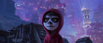 Movie still from “Coco” (2017), directed by Adrian Molina – A child dressed in a red hooded sweatshirt and a red hooded sweatshirt; Close Up shot, Over the shoulder angle