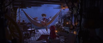 Movie still from “Coco” (2017), directed by Adrian Molina – A person sitting in a hammock on a dock; Wide shot, High angle