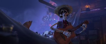 Movie still from “Coco” (2017), directed by Adrian Molina – A skeleton with a hat and a guitar; Medium shot, Low angle