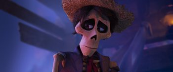 Movie still from “Coco” (2017), directed by Adrian Molina – A skeleton wearing a straw hat and a purple suit; Close Up shot, Low angle