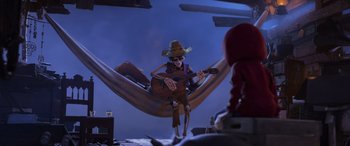 Movie still from “Coco” (2017), directed by Adrian Molina – A skeleton playing a guitar while sitting in a hammock; Wide shot, Low angle