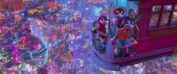 Movie still from “Coco” (2017), directed by Adrian Molina – A couple of people that are sitting in a chair; Wide shot, Low angle