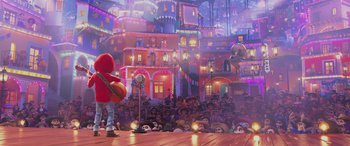Movie still from “Coco” (2017), directed by Adrian Molina – A crowd of people sitting in front of a stage; Wide shot, Low angle