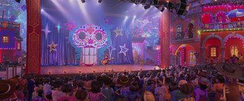 Movie still from “Coco” (2017), directed by Adrian Molina – A crowd of people sitting on a stage watching a performance; Extreme Wide shot, Over the shoulder angle