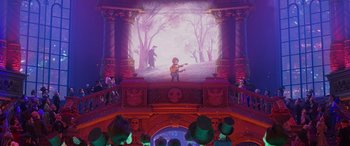 Movie still from “Coco” (2017), directed by Adrian Molina – An image of a man playing a guitar on stage; Wide shot, Over the shoulder angle