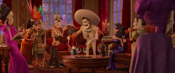 Movie still from “Coco” (2017), directed by Adrian Molina – A group of people sitting around a living room; Wide shot, Over the shoulder angle