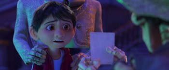 Movie still from “Coco” (2017), directed by Adrian Molina – A boy is holding a piece of paper in his hand; Close Up shot, Over the shoulder angle
