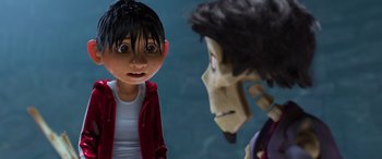 Movie still from “Coco” (2017), directed by Adrian Molina – A boy and a girl talking to each other in front of a blue wall; Close Up shot, Over the shoulder angle