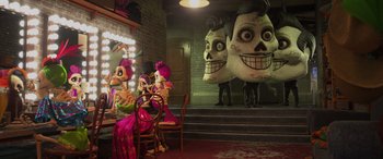 Movie still from “Coco” (2017), directed by Adrian Molina – A group of people sitting at a table with skulls on them; Wide shot, Over the shoulder angle