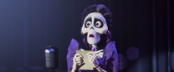 Movie still from “Coco” (2017), directed by Adrian Molina – A woman in a purple dress holding a piece of paper; Close Up shot, Over the shoulder angle