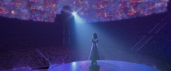 Movie still from “Coco” (2017), directed by Adrian Molina – A woman standing in front of a stage with lights; Extreme Wide shot, Low angle