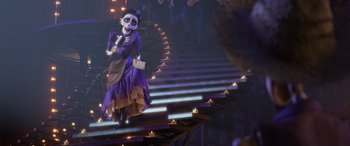 Movie still from “Coco” (2017), directed by Adrian Molina – A woman dressed as a skeleton singing on a staircase; Wide shot, Over the shoulder angle