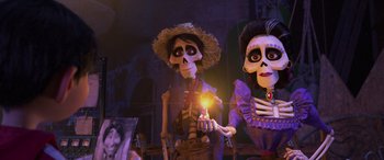 Movie still from “Coco” (2017), directed by Adrian Molina – A couple of people that are dressed up like skeletons; Medium shot, Low angle