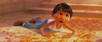 Movie still from “Coco” (2017), directed by Adrian Molina – A boy laying on the ground looking surprised; Medium shot, Low angle