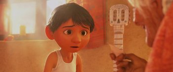 Movie still from “Coco” (2017), directed by Adrian Molina – A young boy is looking at a guitar; Close Up shot, Over the shoulder angle