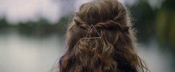 Movie still from “Color Out of Space” (2019), directed by Richard Stanley – A hair clip on the back of a woman's head; Extreme Close Up shot, Overhead angle