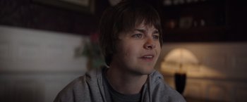 Movie still from “Color Out of Space” (2019), directed by Richard Stanley – A young man is looking into the distance; Close Up shot, Over the shoulder angle