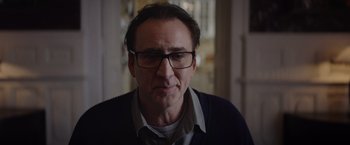 Movie still from “Color Out of Space” (2019), directed by Richard Stanley – A person wearing glasses and a sweater; Close Up shot, Over the shoulder angle