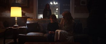 Movie still from “Color Out of Space” (2019), directed by Richard Stanley – Two women and a boy are sitting on a couch; Medium shot, Over the shoulder angle