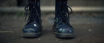 Movie still from “Color Out of Space” (2019), directed by Richard Stanley – View of a pair of boots; Extreme Close Up shot, Low angle