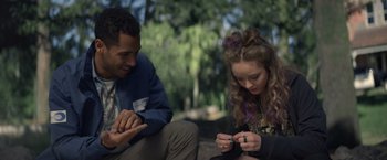 Movie still from “Color Out of Space” (2019), directed by Richard Stanley – A man and a woman sitting next to each other on the ground; Medium shot, Over the shoulder angle