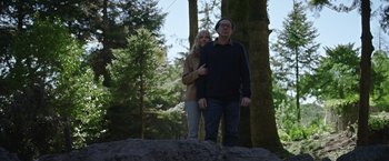 Movie still from “Color Out of Space” (2019), directed by Richard Stanley – A man and a woman standing on top of a hill; Wide shot, Low angle