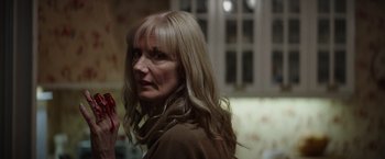 Movie still from “Color Out of Space” (2019), directed by Richard Stanley – A woman with long blonde hair is looking to her left; Close Up shot, Over the shoulder angle