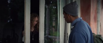 Movie still from “Color Out of Space” (2019), directed by Richard Stanley – A man and a woman standing next to each other in front of a window; Medium shot, Over the shoulder angle