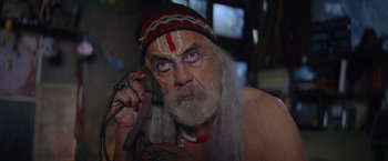 Movie still from “Color Out of Space” (2019), directed by Richard Stanley – An old man with long white hair talking on a phone; Close Up shot, Low angle