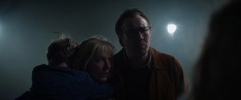 Movie still from “Color Out of Space” (2019), directed by Richard Stanley – A man and a woman standing next to each other in the dark; Close Up shot, Low angle