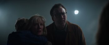 Movie still from “Color Out of Space” (2019), directed by Richard Stanley – A man and a woman standing next to each other in the dark; Close Up shot, Low angle