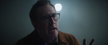 Movie still from “Color Out of Space” (2019), directed by Richard Stanley – A person wearing glasses; Close Up shot, Over the shoulder angle