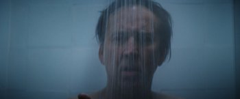 Movie still from “Color Out of Space” (2019), directed by Richard Stanley – A man is taking a shower in the bathroom; Extreme Close Up shot, Low angle