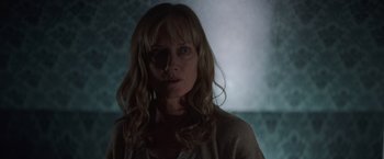 Movie still from “Color Out of Space” (2019), directed by Richard Stanley – A woman with long blonde hair wearing a white shirt; Close Up shot, Low angle