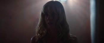Movie still from “Color Out of Space” (2019), directed by Richard Stanley – A woman with blonde hair and a white shirt; Close Up shot, Low angle