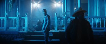 Movie still from “Color Out of Space” (2019), directed by Richard Stanley – A man standing in a dark room at night; Wide shot, Low angle