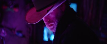 Movie still from “Color Out of Space” (2019), directed by Richard Stanley – A man with a beard and a cowboy hat; Close Up shot, Low angle