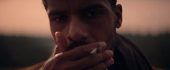 Movie still from “Color Out of Space” (2019), directed by Richard Stanley – A person holding a cigarette in his mouth; Extreme Close Up shot, Over the shoulder angle