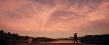 Movie still from “Color Out of Space” (2019), directed by Richard Stanley – A man walking on a boardwalk near a body of water; Extreme Wide shot, Low angle