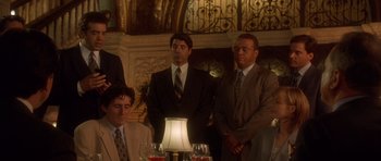 Movie still from “The Usual Suspects” (1995), directed by Bryan Singer – A group of men standing around a dinner table; Medium shot, Low angle