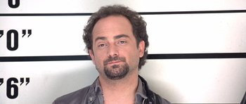 Movie still from “The Usual Suspects” (1995), directed by Bryan Singer – A person with a beard; Close Up shot, Low angle