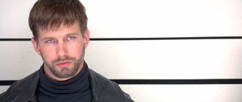 Movie still from “The Usual Suspects” (1995), directed by Bryan Singer – A person wearing a black jacket; Close Up shot, Low angle