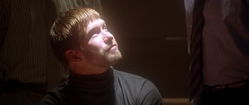 Movie still from “The Usual Suspects” (1995), directed by Bryan Singer – A man with his eyes closed looking upward; Close Up shot, Low angle