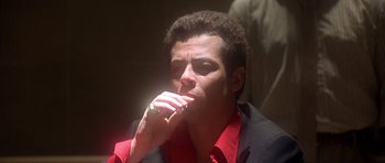 Movie still from “The Usual Suspects” (1995), directed by Bryan Singer – A person wearing a suit and tie; Close Up shot, Low angle