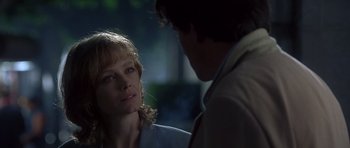 Movie still from “The Usual Suspects” (1995), directed by Bryan Singer – A man and a woman standing next to each other in the dark; Close Up shot, Over the shoulder angle